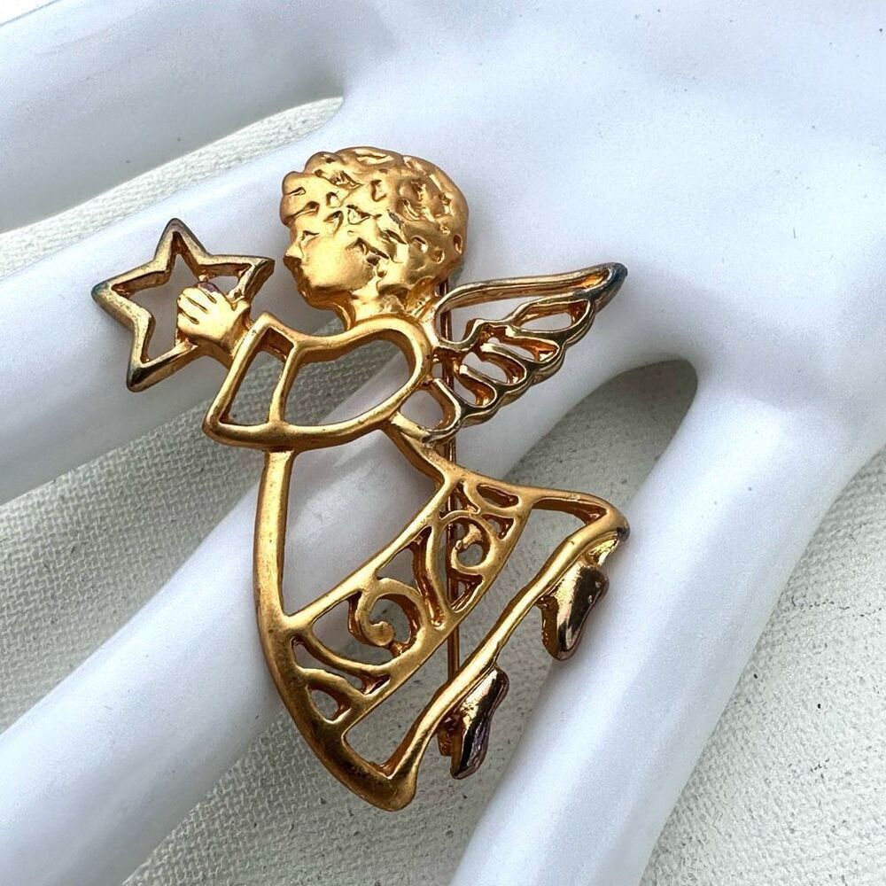 Gold tone angel holding star brooch